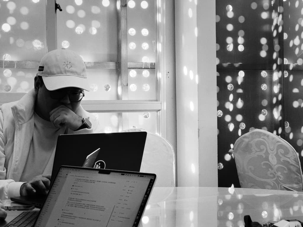 Founder (Cali) is working on the laptop.